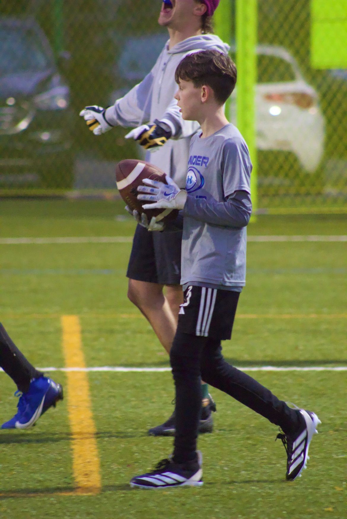 Young football athlete at an evening ScoutSync development session