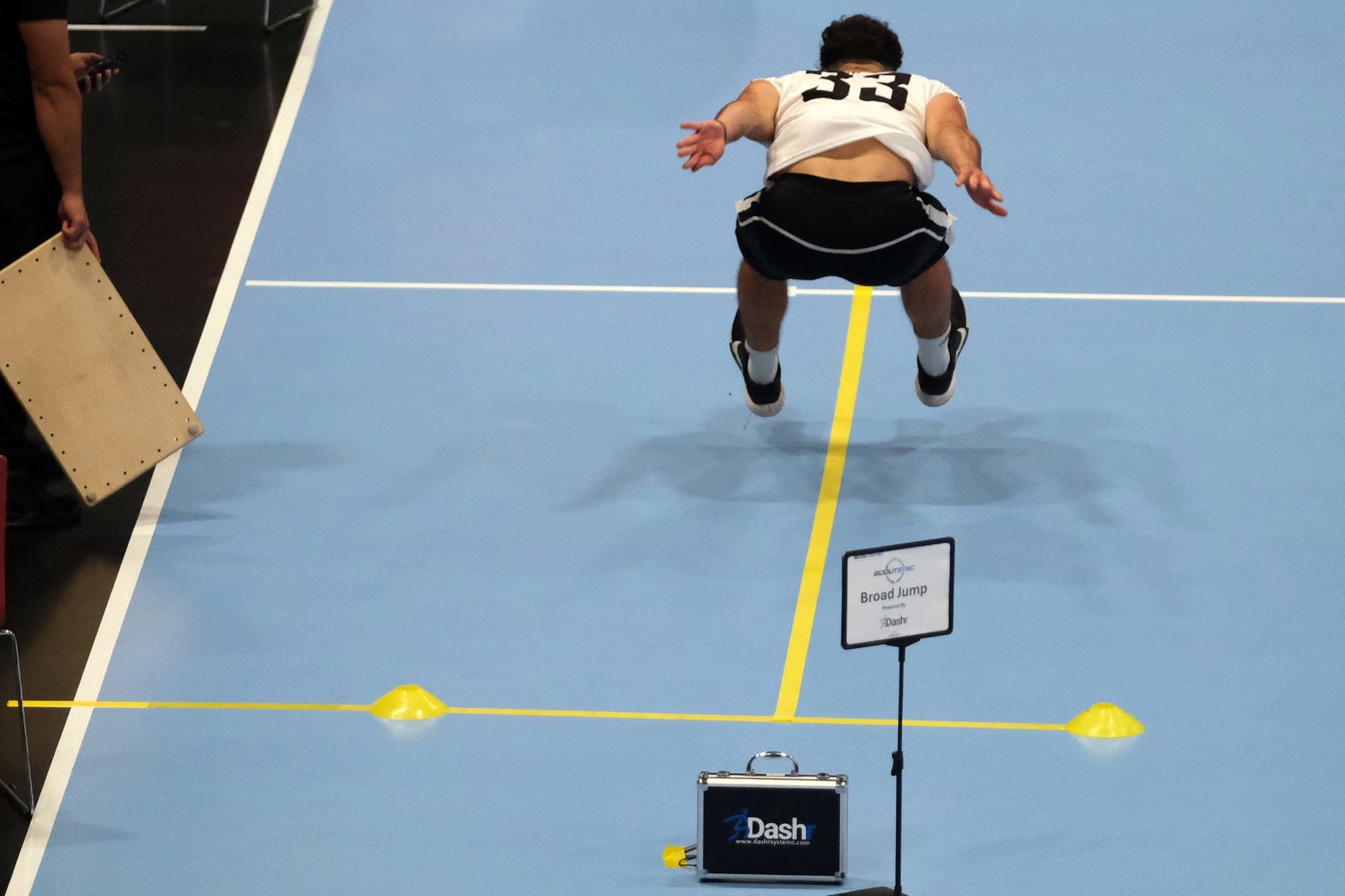 Athlete performing the broad jump at a ScoutSync combine station powered by Dashr